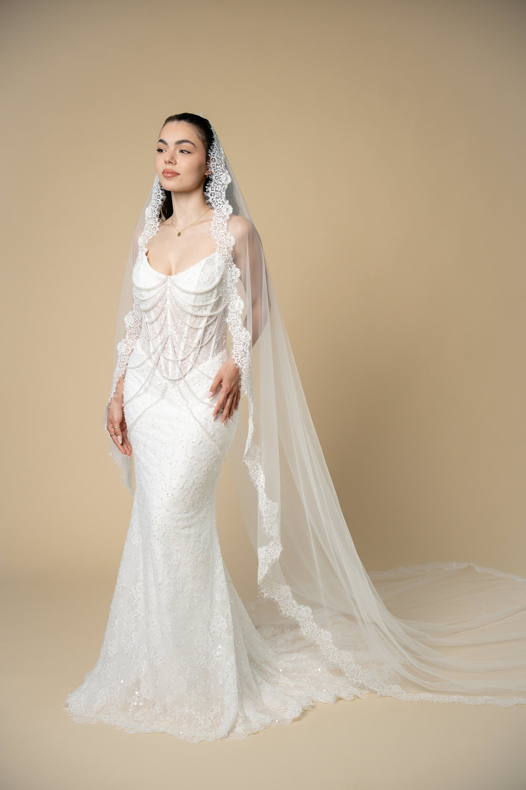 Bride wearing the Adella cathedral wedding veil with luxurious lace, pearls, sequins and eyelash lace edging by Aoura Veil