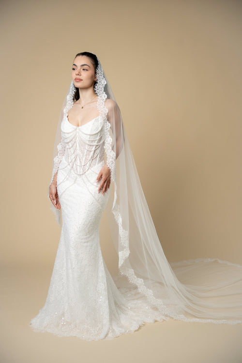 Bride wearing the Adella cathedral wedding veil with luxurious lace, pearls, sequins and eyelash lace edging by Aoura Veil