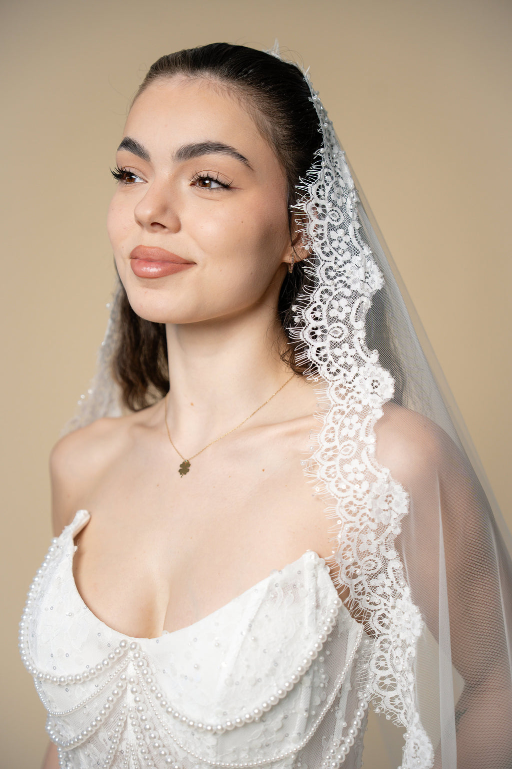 Close-up of the Adella cathedral wedding veil featuring lace embellished with pearls, sequins and delicate eyelash fringe by Aoura Veil