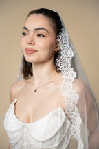 Close-up of the Adella cathedral wedding veil featuring lace embellished with pearls, sequins and delicate eyelash fringe by Aoura Veil