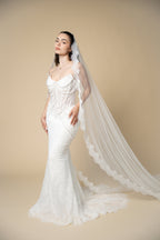 Bride wearing the Adella cathedral wedding veil with luxurious lace, pearls, sequins and eyelash lace edging by Aoura Veil