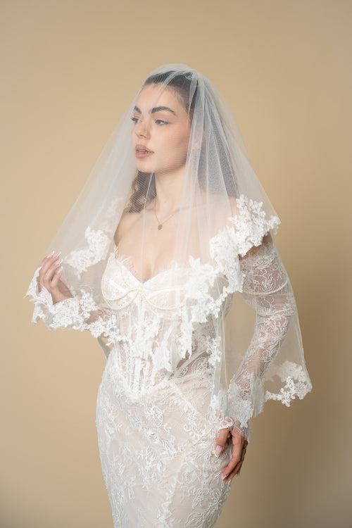 Bride wearing the Agatha short wedding veil with blusher and handcrafted 3D floral lace