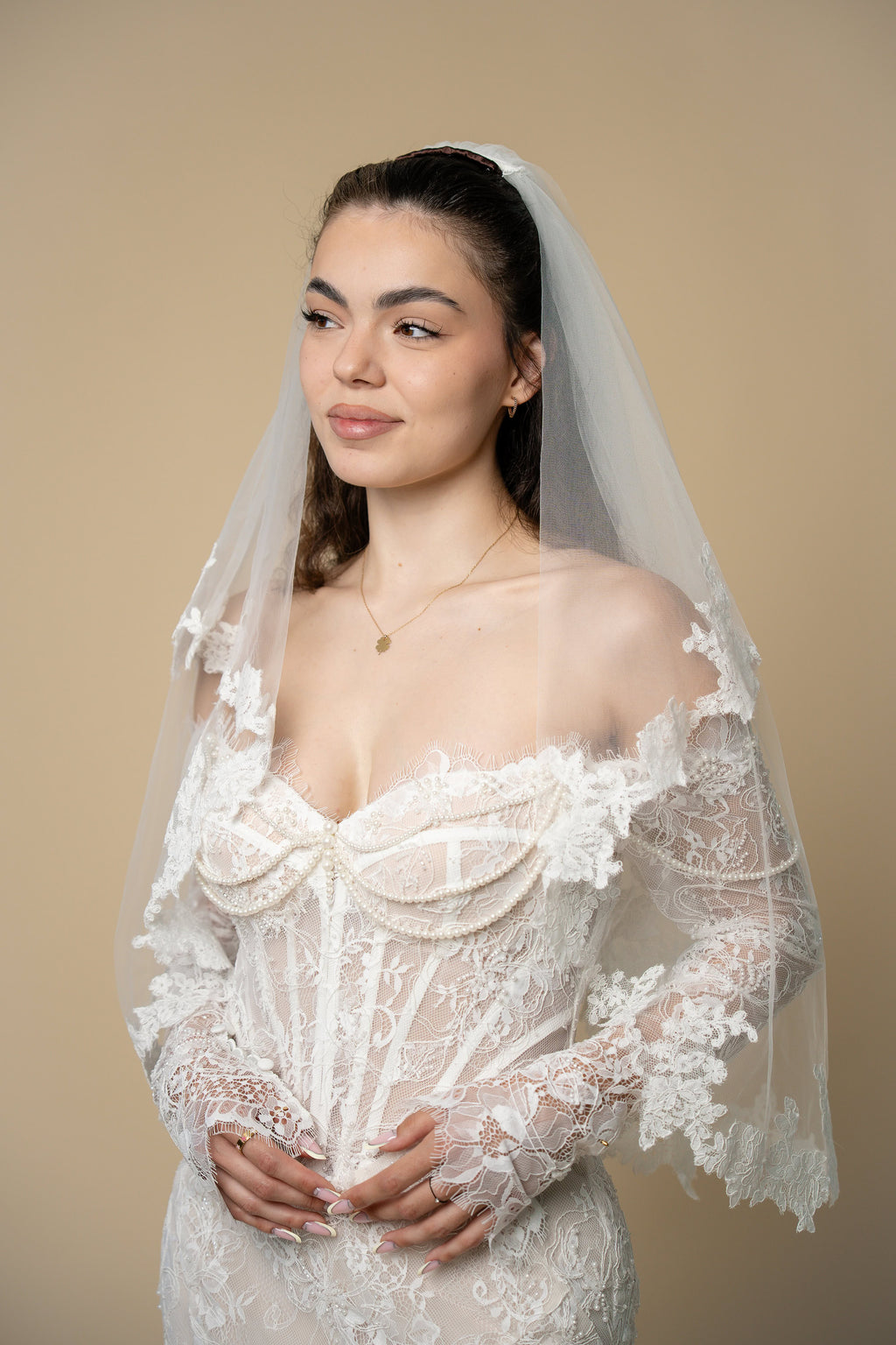 Bride wearing the Agatha short wedding veil with elegant 3D floral lace by Aoura Veil