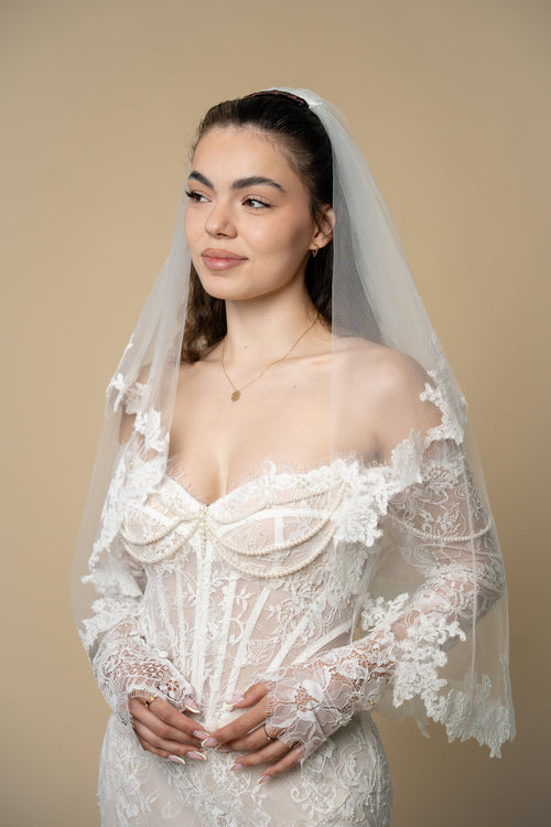 Bride wearing the Agatha short wedding veil with elegant 3D floral lace by Aoura Veil