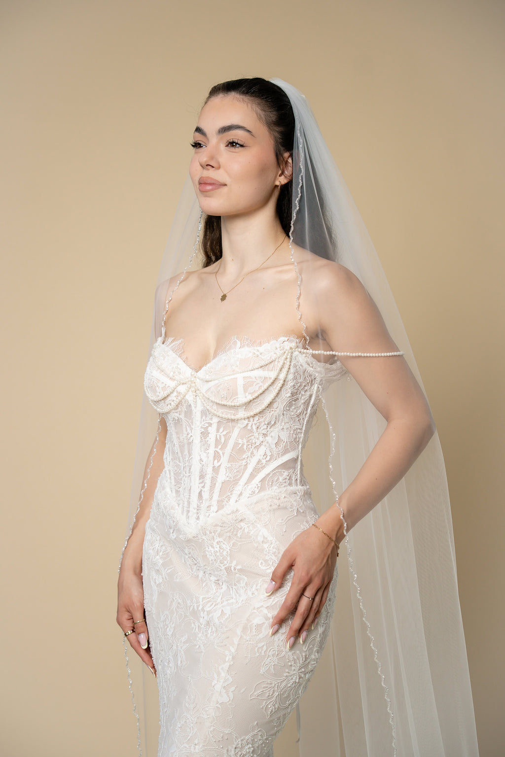 Bride wearing the Ava cathedral wedding veil with elegant handcrafted glass crystal trim by Aoura Veil