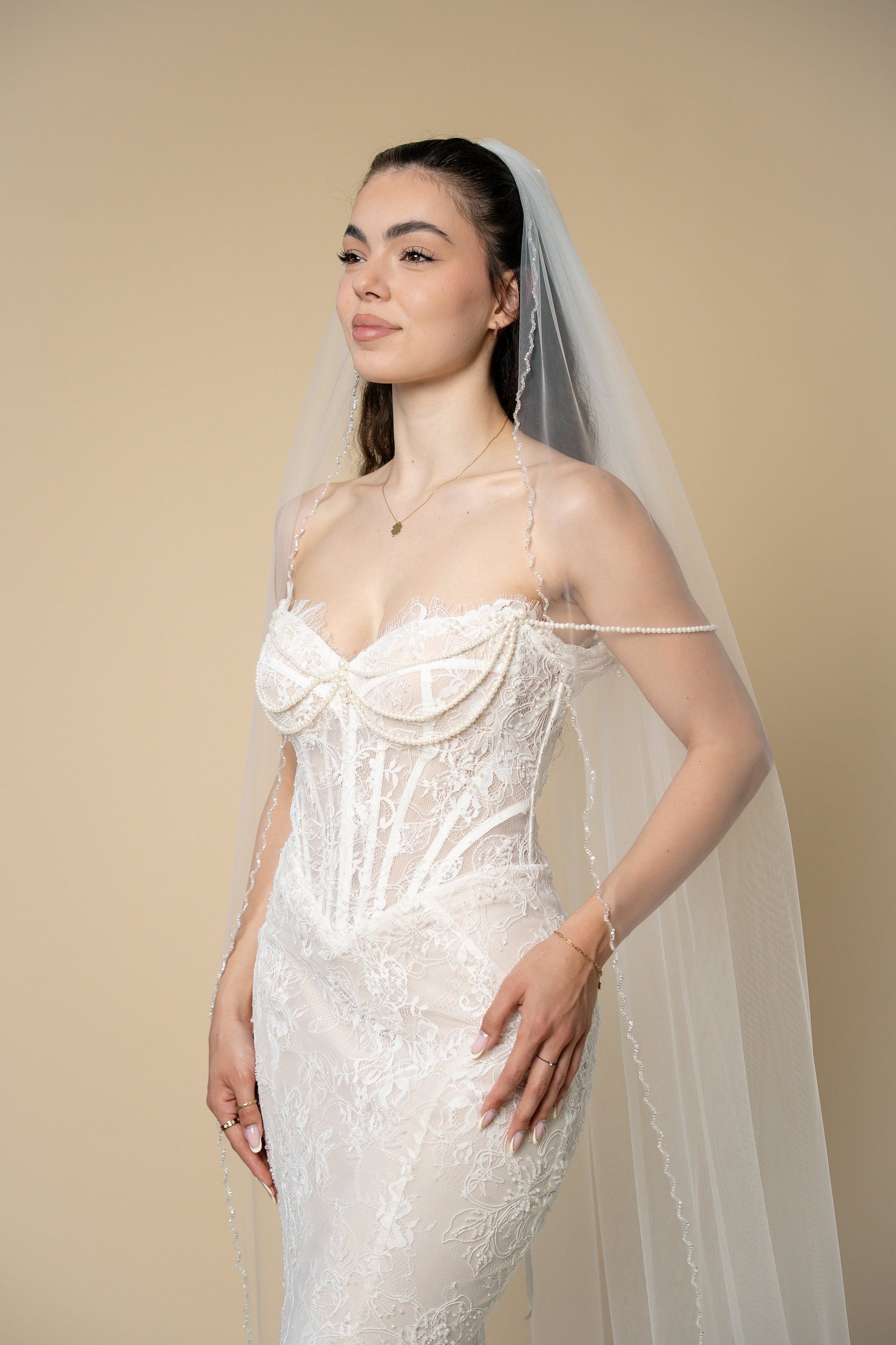 Bride wearing the Ava cathedral wedding veil with elegant handcrafted glass crystal trim by Aoura Veil