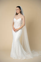 Bride wearing the Brisa cathedral wedding veil with a shimmering sequined and crystal edge by Aoura Veil