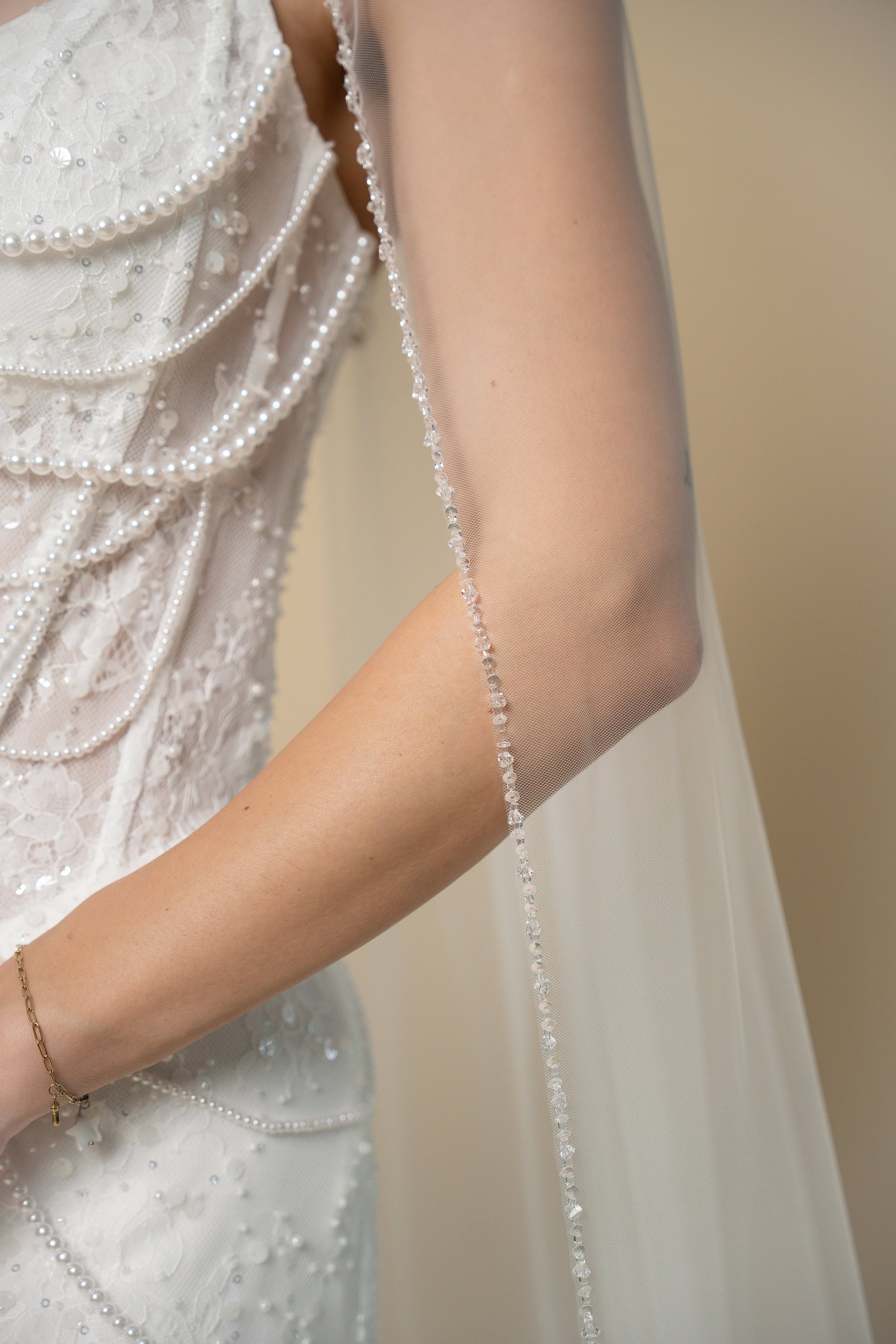 Close-up of the Brisa cathedral wedding veil featuring a hand-finished edge with sequins and sparkling crystals by Aoura Veil