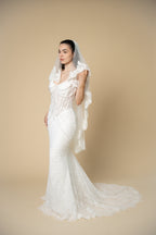 Elegant full-length view of the Clara cathedral bridal veil with handcrafted 3D floral lace edging and delicate eyelash fringe by Aoura Veil
