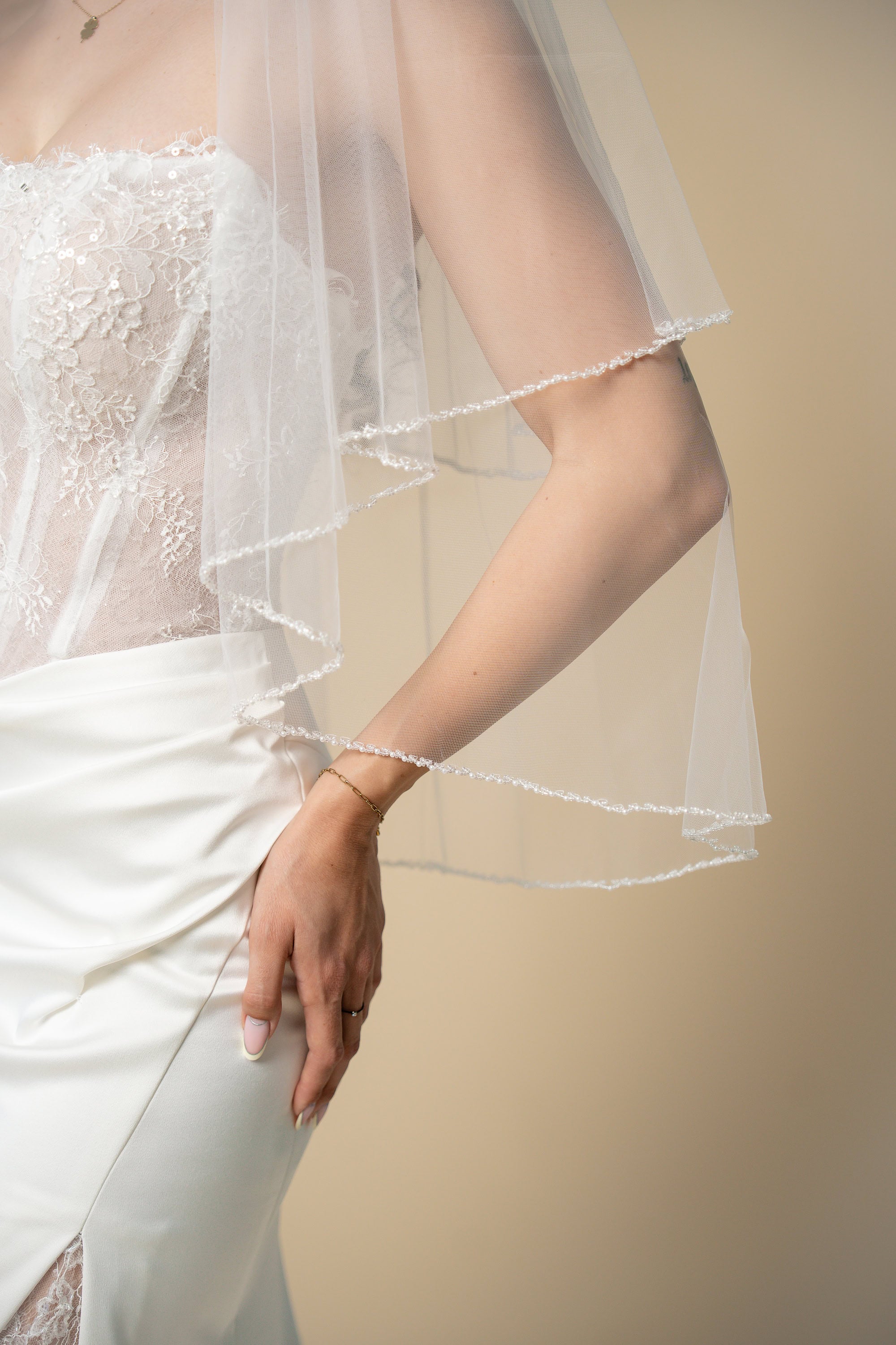Close-up of the Darla bridal veil showcasing the handcrafted pearl and crystal X border