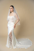 Darla short wedding veil featuring a delicate X-pattern edge handcrafted with pearls and crystals by Aoura Veil