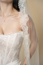 Close-up of Diane cathedral wedding veil with delicate floral eyelash lace and petal details