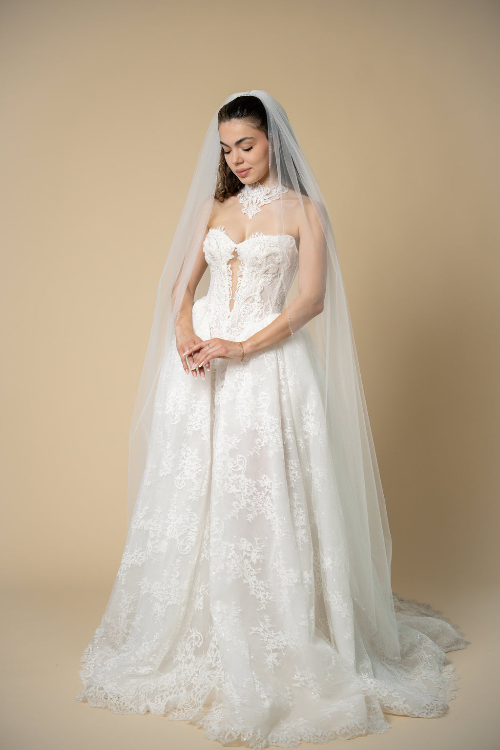 Bride wearing the Edith pearl cathedral wedding veil with elegant linear pearl and crystal embellishments by Aoura Veil