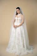 Bride wearing the Edith pearl cathedral wedding veil with elegant linear pearl and crystal embellishments by Aoura Veil