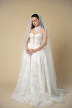 Bride wearing the Edith pearl cathedral wedding veil with elegant linear pearl and crystal embellishments by Aoura Veil