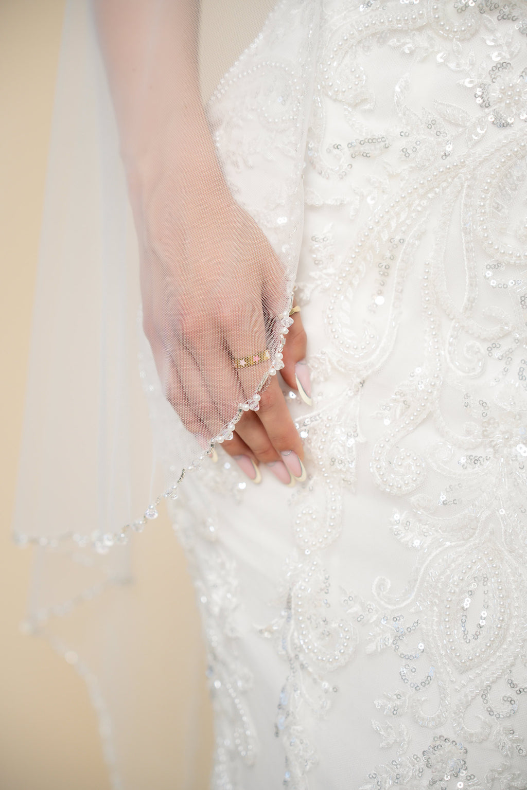 Close-up of the Elora cathedral wedding veil featuring a handcrafted vertical strand of pearls, crystals and stones along the edge by Aoura Veil