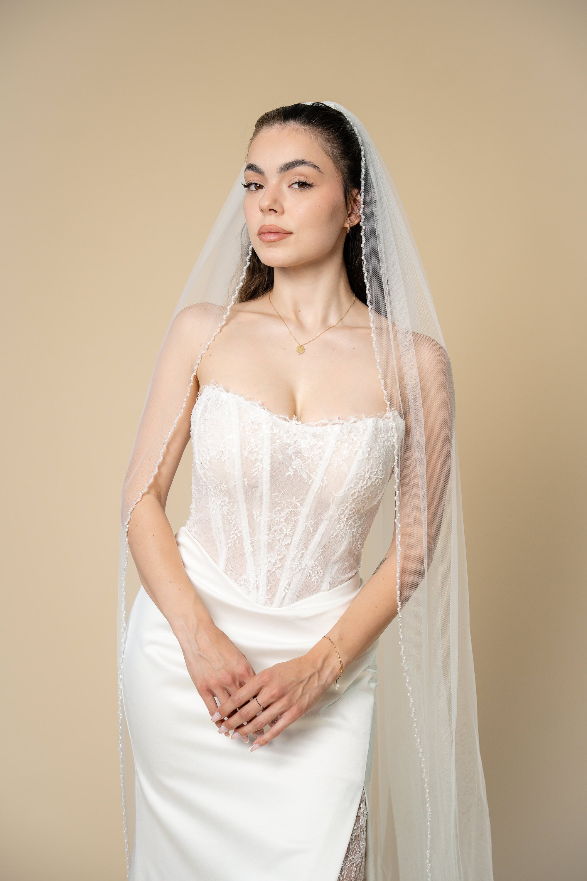 Front view of Emira cathedral wedding veil with elegant V-shaped pearl and crystal border