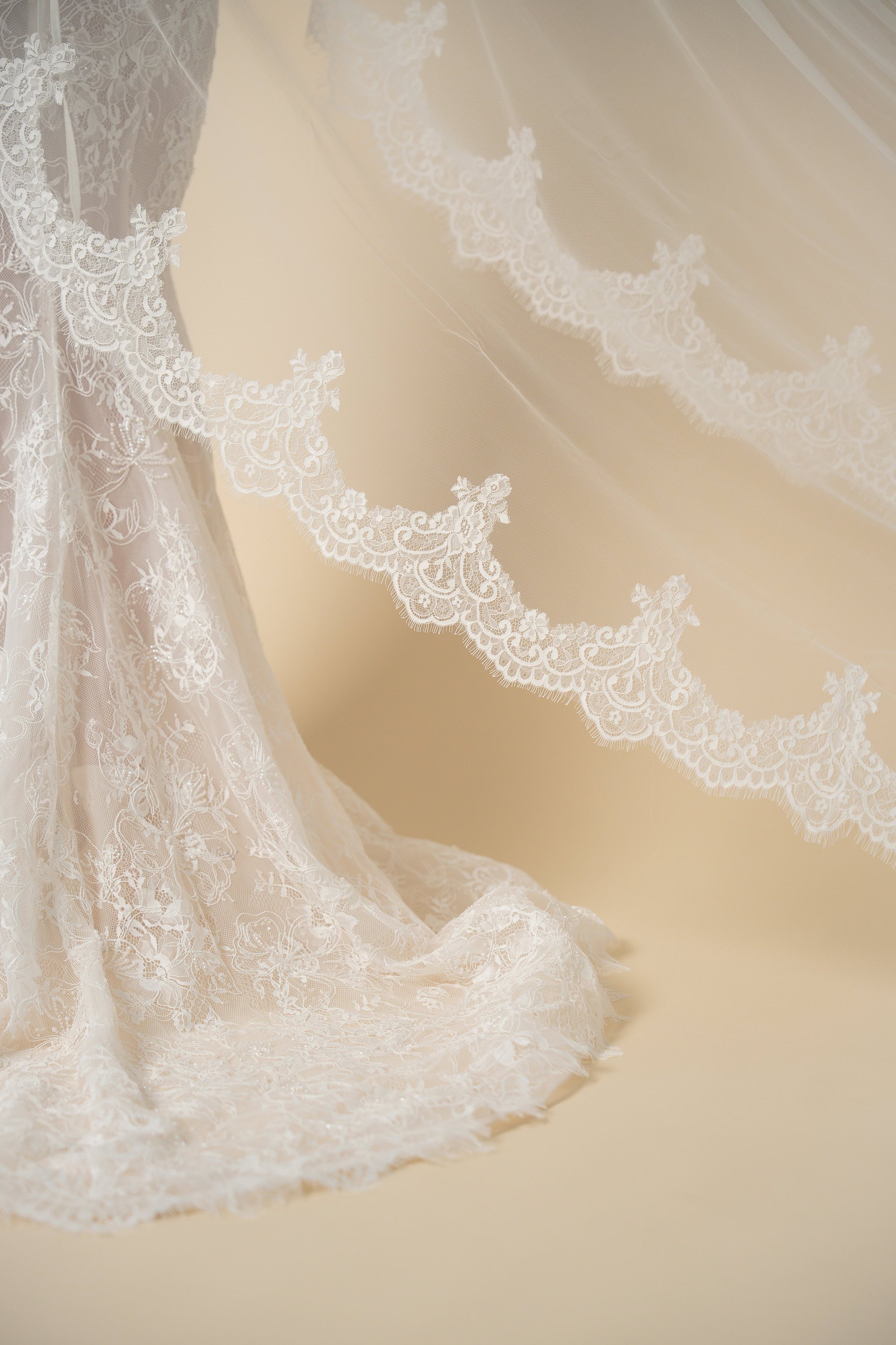 Close-up detail of the Freya cathedral wedding veil featuring luxurious scalloped lace with eyelash fringe