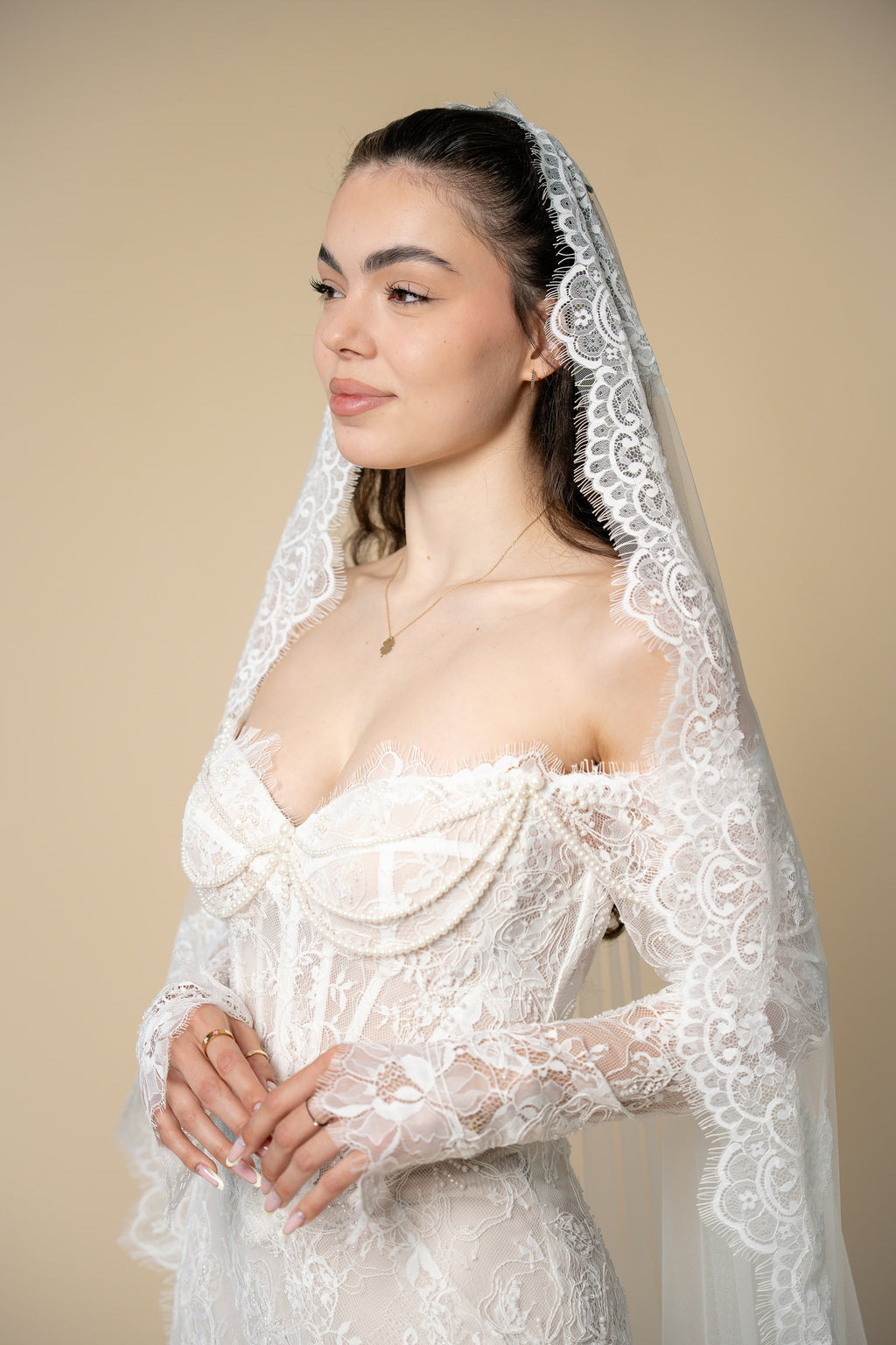 Bride wearing the Freya cathedral wedding veil with luxurious U-shaped lace and eyelash fringe by Aoura Veil