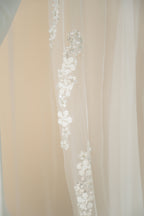 Close-up of hand-sewn floral strands on Hellen cathedral wedding veil