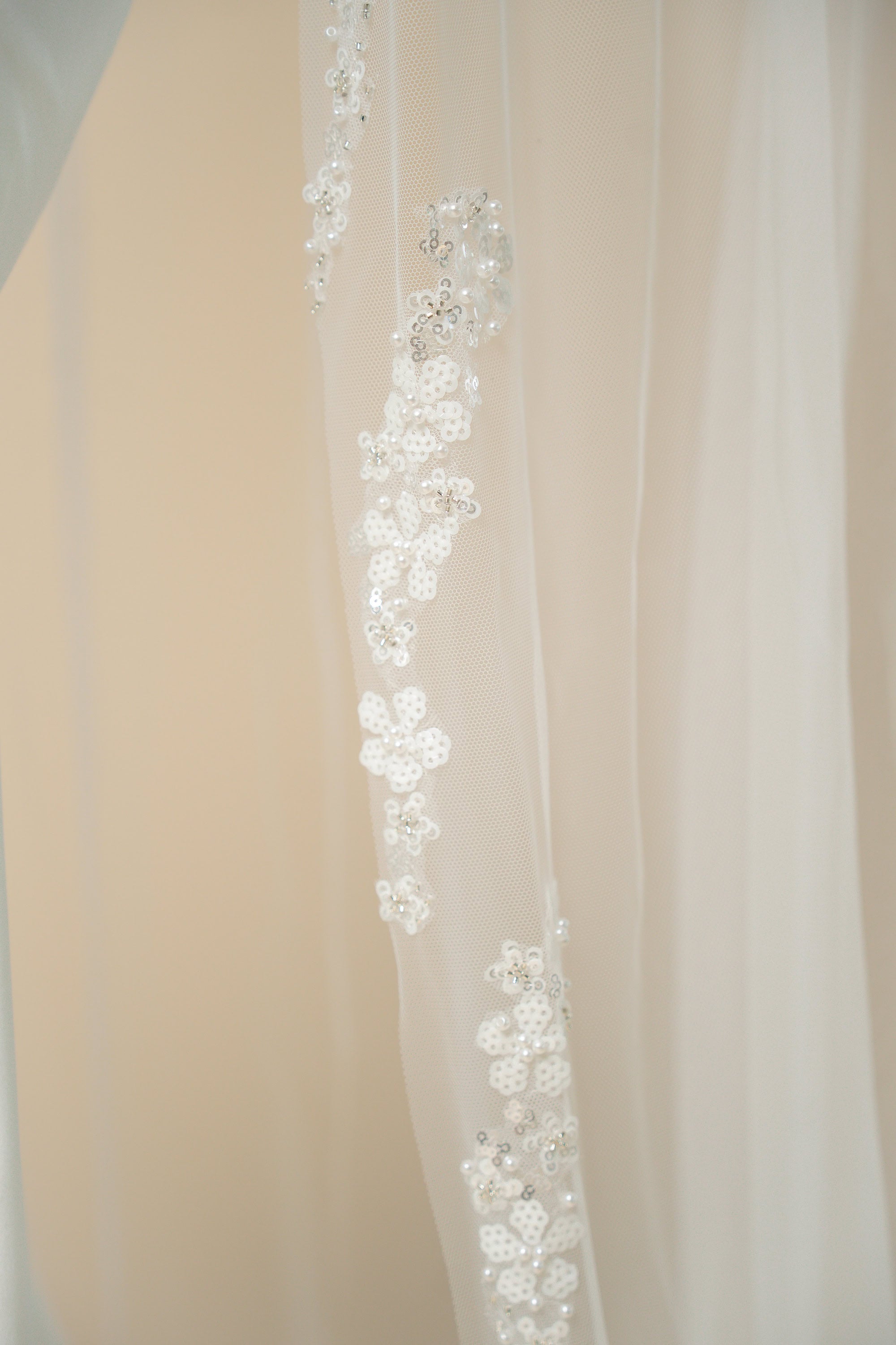 Close-up of hand-sewn floral strands on Hellen cathedral wedding veil