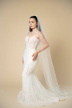Bride wearing the Ivana cathedral bridal veil with subtle sparkling crystal embellishments throughout the tulle by Aoura Veil