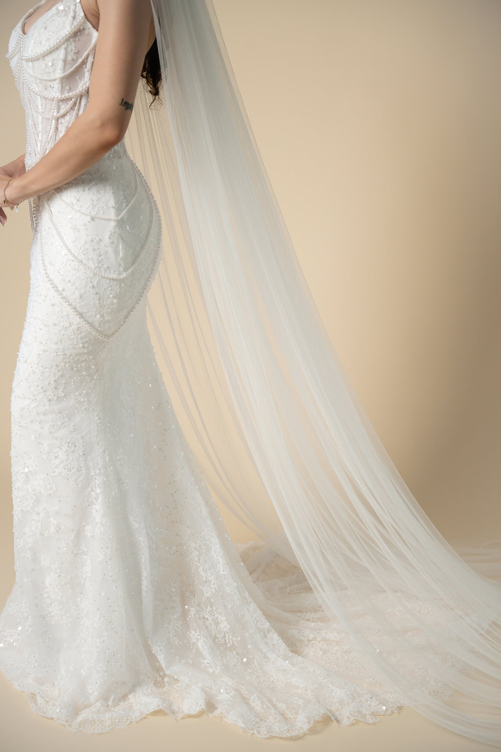 Close-up of the Jolie simple cathedral wedding veil showcasing its soft flowing tulle and elegant drape by Aoura Veil
