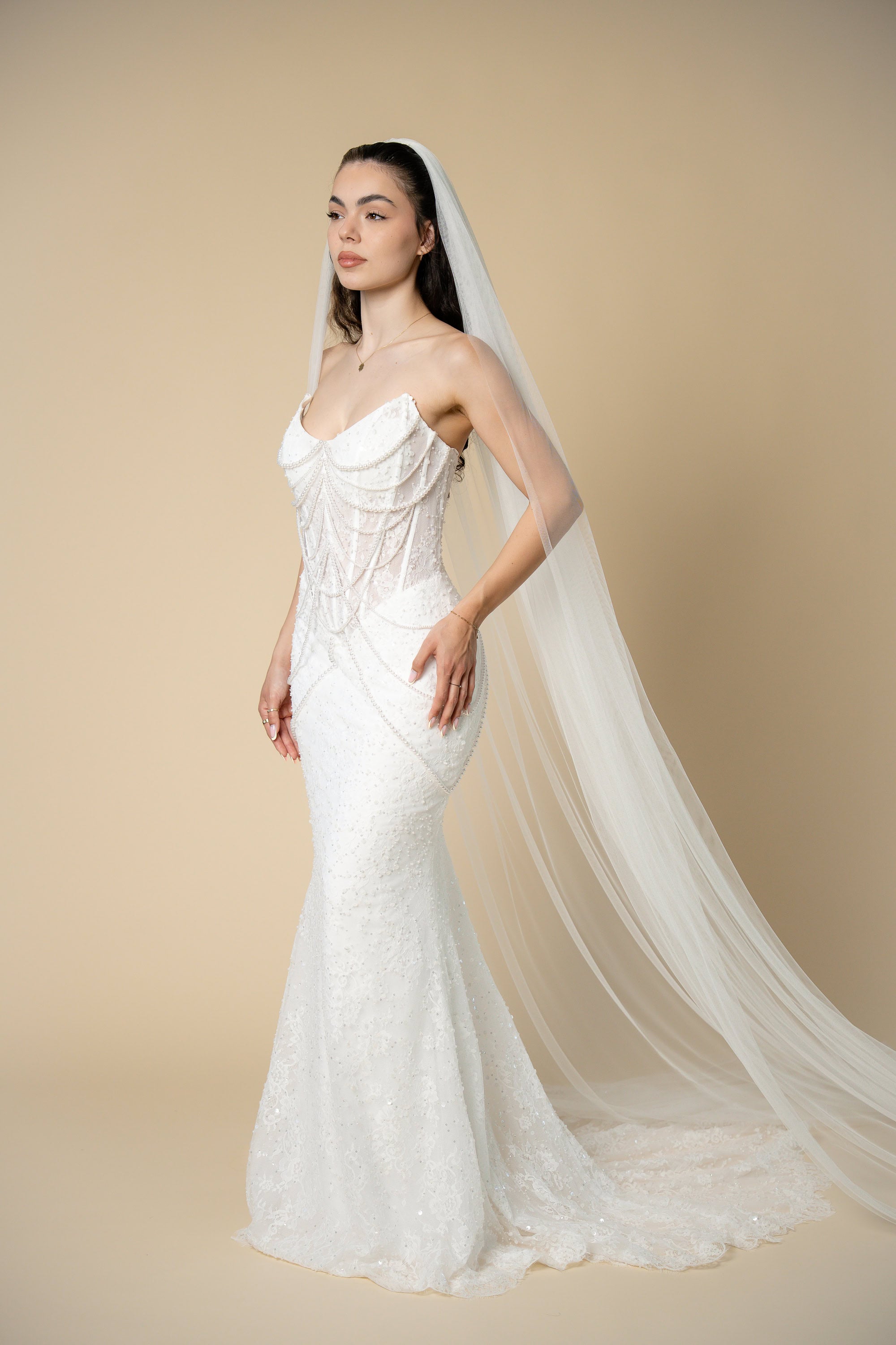 Bride wearing the Jolie simple cathedral wedding veil with a luxurious flowing silhouette and timeless elegance by Aoura Veil