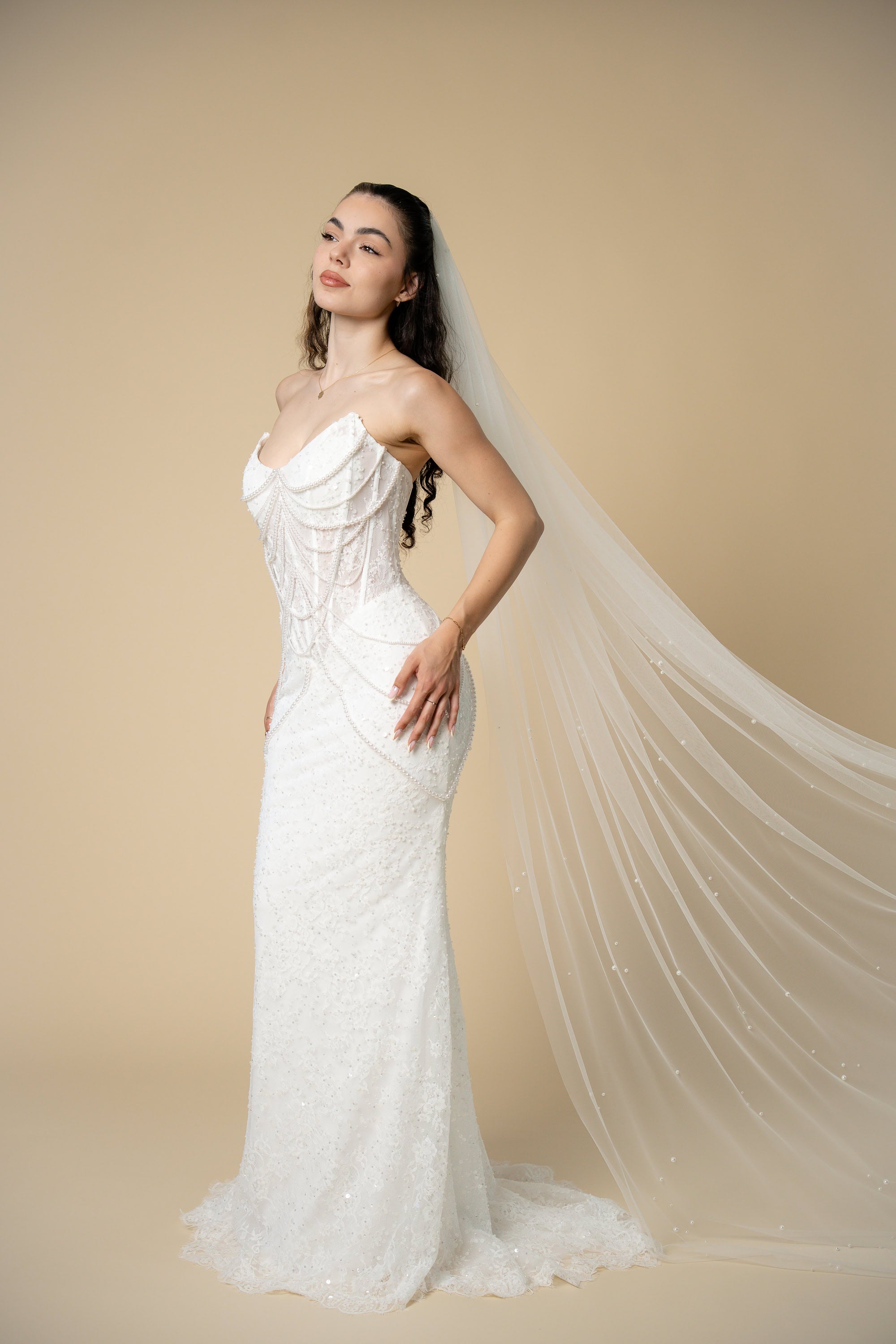Luxury Poppy cathedral wedding veil featuring scattered pearl clusters throughout the full length of the veil by Aoura Veil