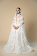 Bride wearing the Sierra luxury cathedral wedding veil with wide floral lace and elegant eyelash fringe by Aoura Veil