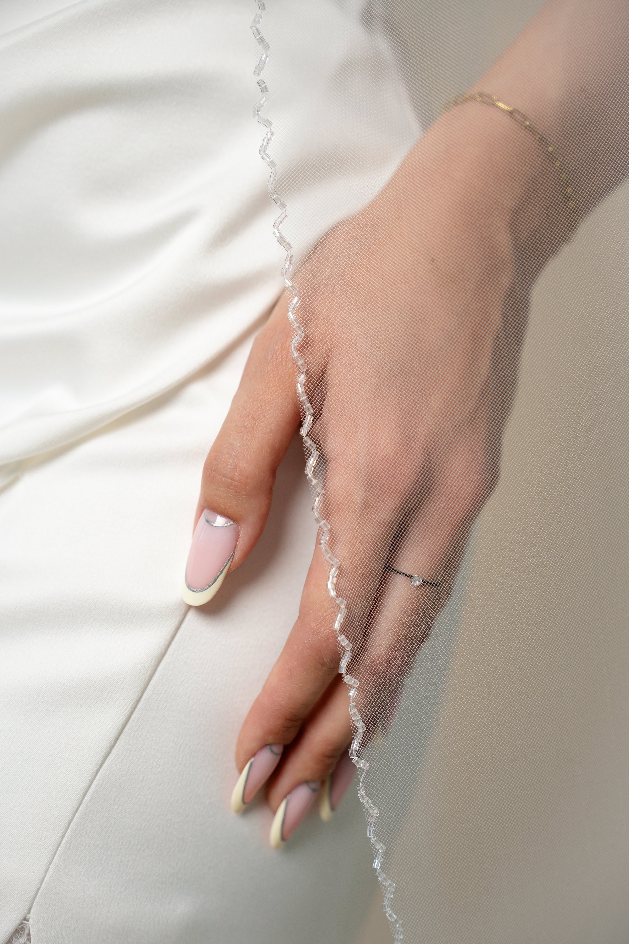Close-up of the Sindy cathedral bridal veil with transparent crystal wave trim