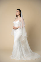Full-length view of the Vivian cathedral wedding veil featuring a refined white satin edge by Aoura Veil