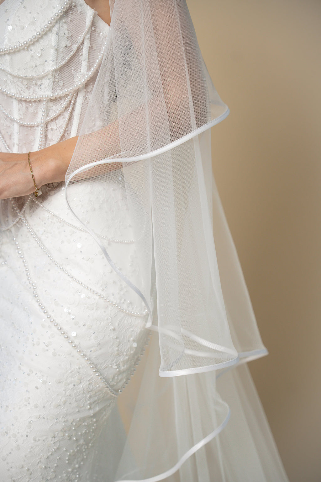 Close-up of the Vivian bridal veil highlighting the delicate white satin trim along the edge by Aoura Veil